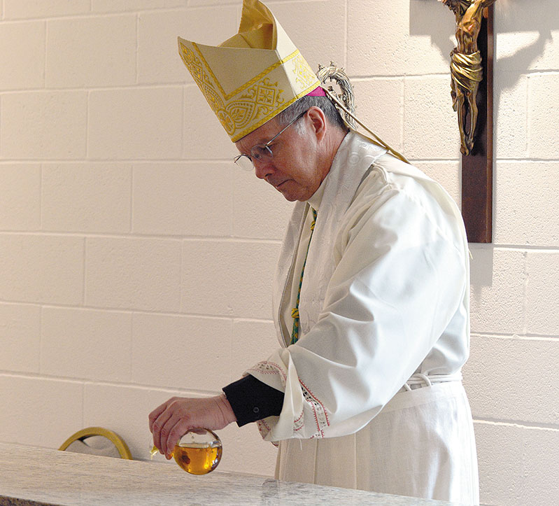 Bishop consecrates altar at Saint Theresa Catholic Scho