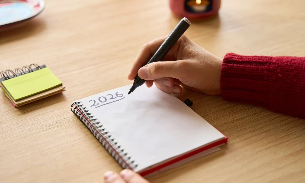 Hand writing 2026 New Year's resolutions