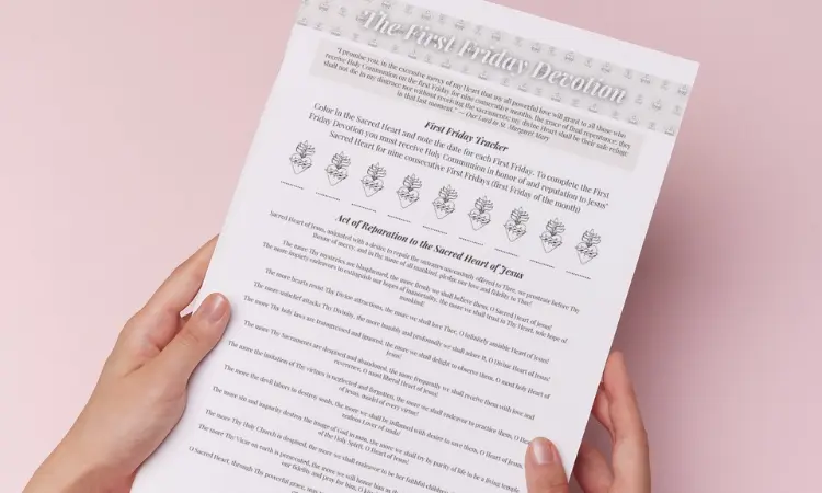 Person holding a printable First Friday Devotion tracke