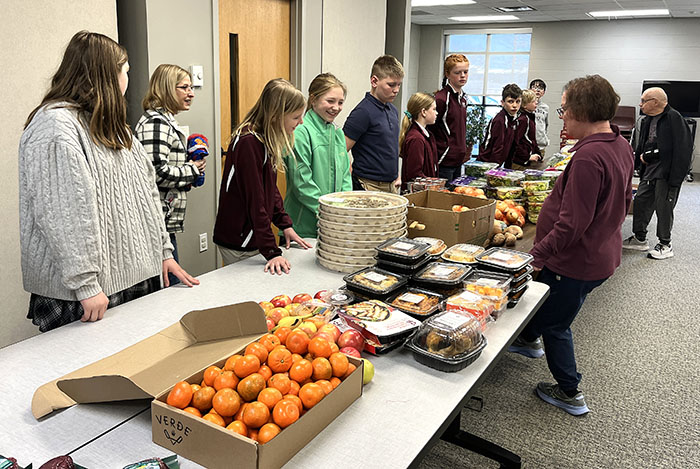 Students serving at the food pantry Students serving at the food pantry