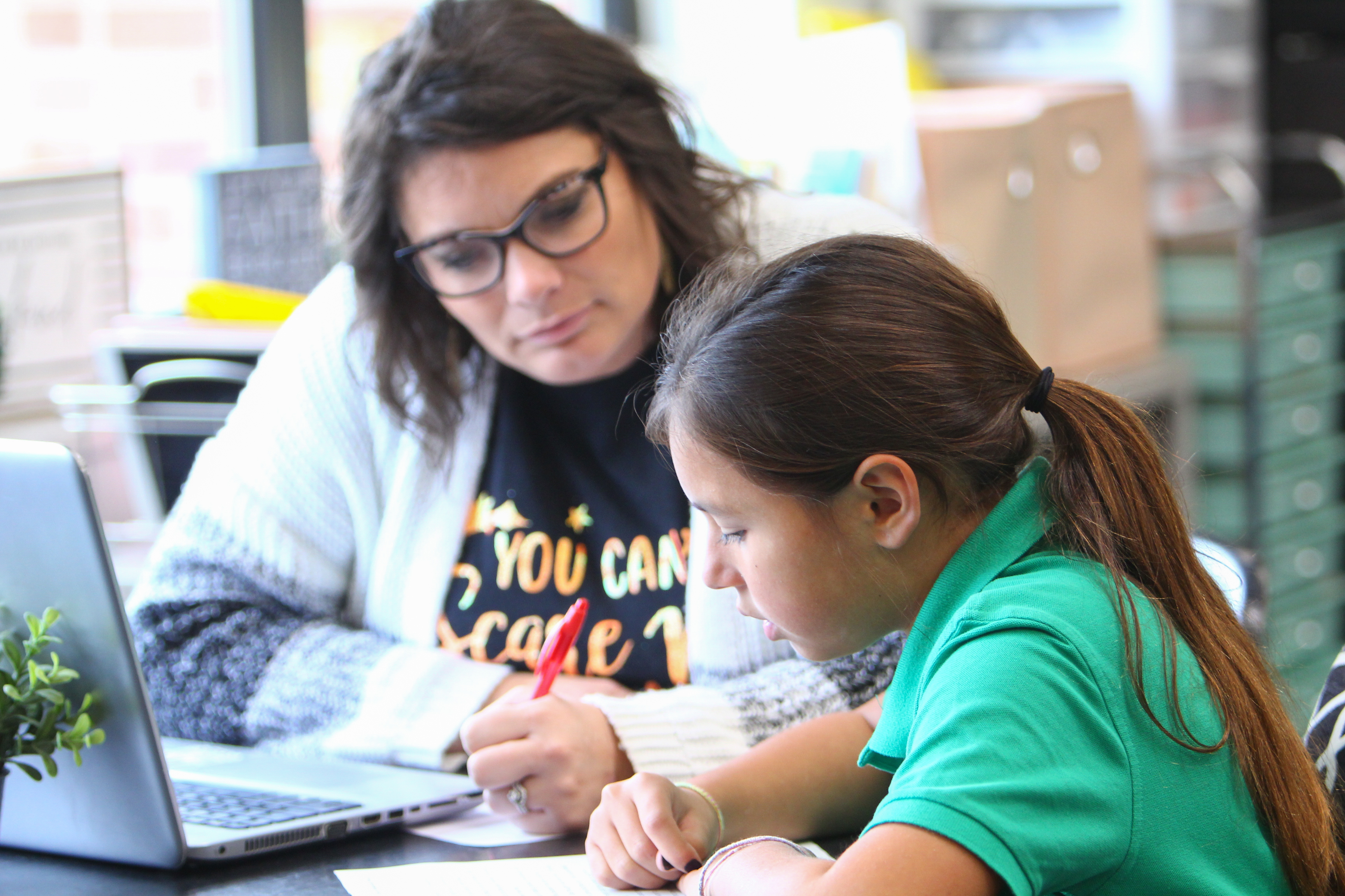 Image of a teacher helping a student