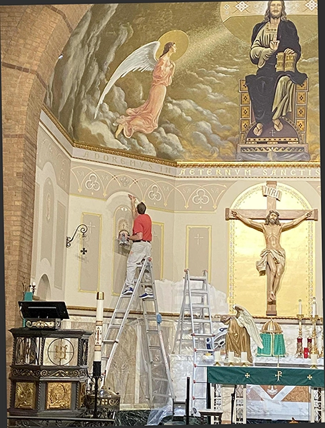 Painter working in the sanctuary of Saint Anthony Catholic Church in Des Moines Painter working in the sanctuary of Saint Anthony Catholic Church in Des Moines