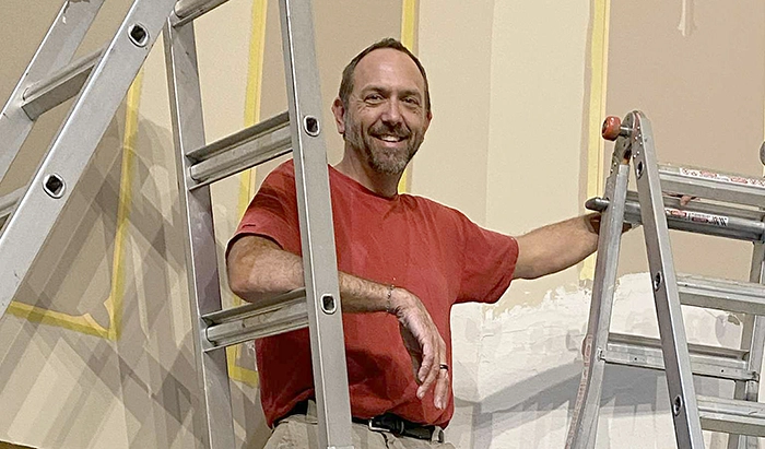 Restoration artist Zack Bunkers meticulously works on t