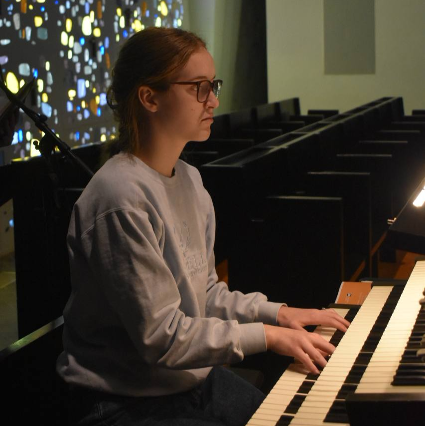 Musica Director at St. Thomas Aquinas in Indianola Emma Lynch plays the piano. 