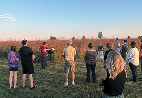 People attend a blessing of a new prairie