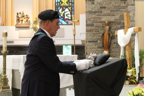 A knight places the silver rose near the altar at Sacre