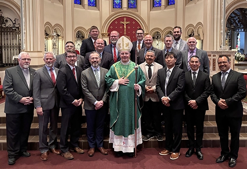 18 men in formation for the permanent diaconate pictured with Bishop Joensen