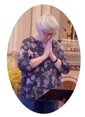 women with gray hair and bowed head and hands praying