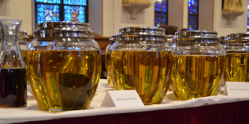 Large glass containers of Sacred Chrism oil and the Oil