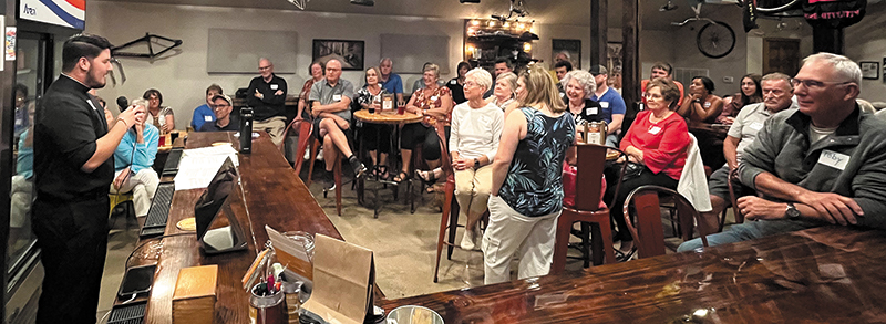 Father Jason Lee talks at a Tap into Faith event