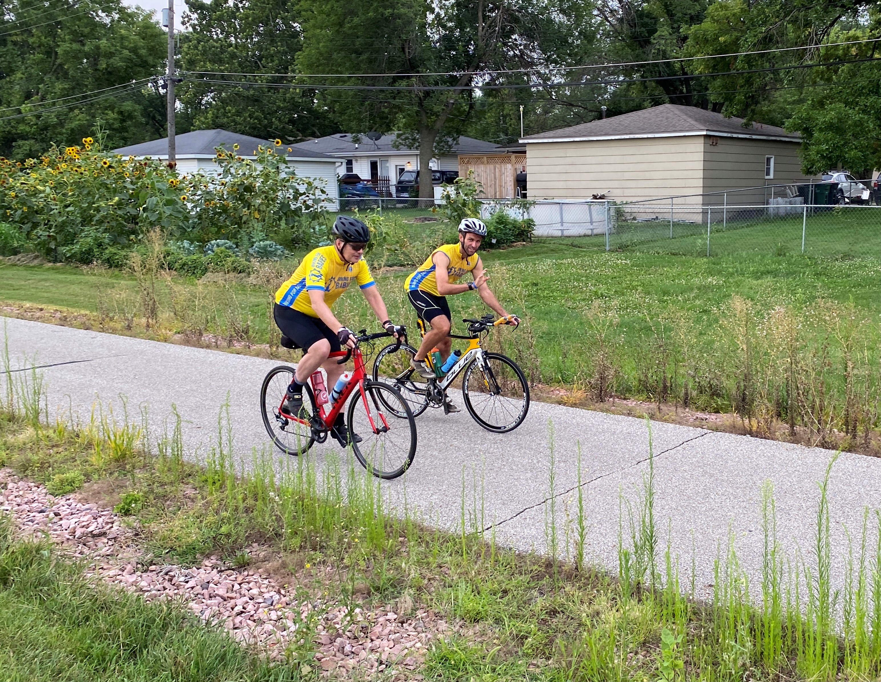 Bishop William Joensen and Jimmy Becker ride bicycles