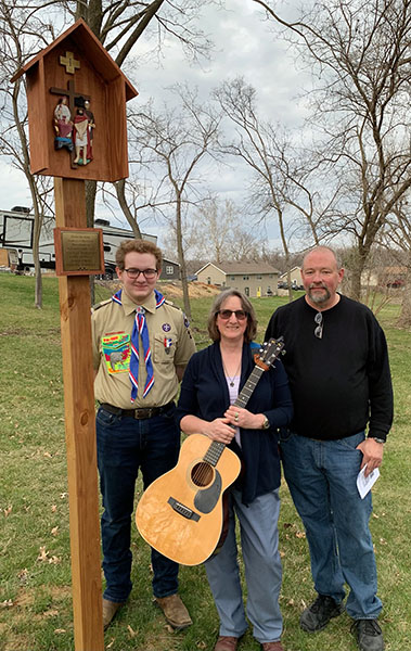 O'Keefe family standing by a station of the cross O'Keefe family standing by a station of the cross