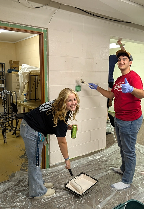 Youth help paint a new room they can call their own for Fully Live Catholic youth group.
