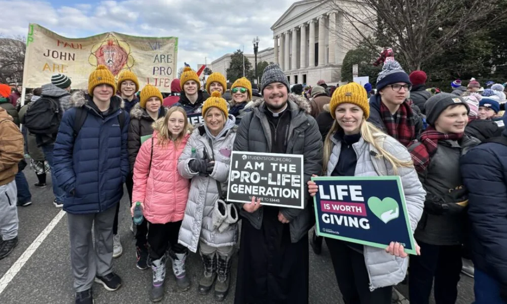Maggie DeWitte, Fr. Jason Lee, and other pilgrims in 20