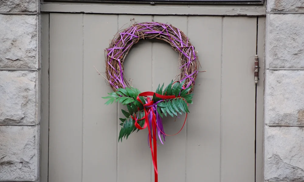 A wreath with purple ribbon