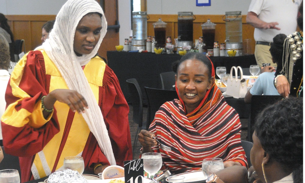 People share foods from different cultures at Rejoice in Our Iowa Refugees: The Faces Behind the Numbers fundraiser. Rejoice in Our Iowa Refugees: The Faces Behind the Numbers fundraiser.