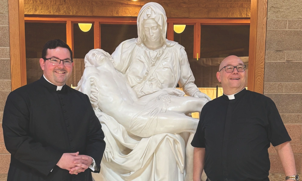 St. Francis of Assisi Parish pariochal vicar Father Alex Kramer and pastor Father Joseph Pins with the new life-sized replica of Michelangelo's Pietà. Father Alex Kramer and Father Joseph Pins