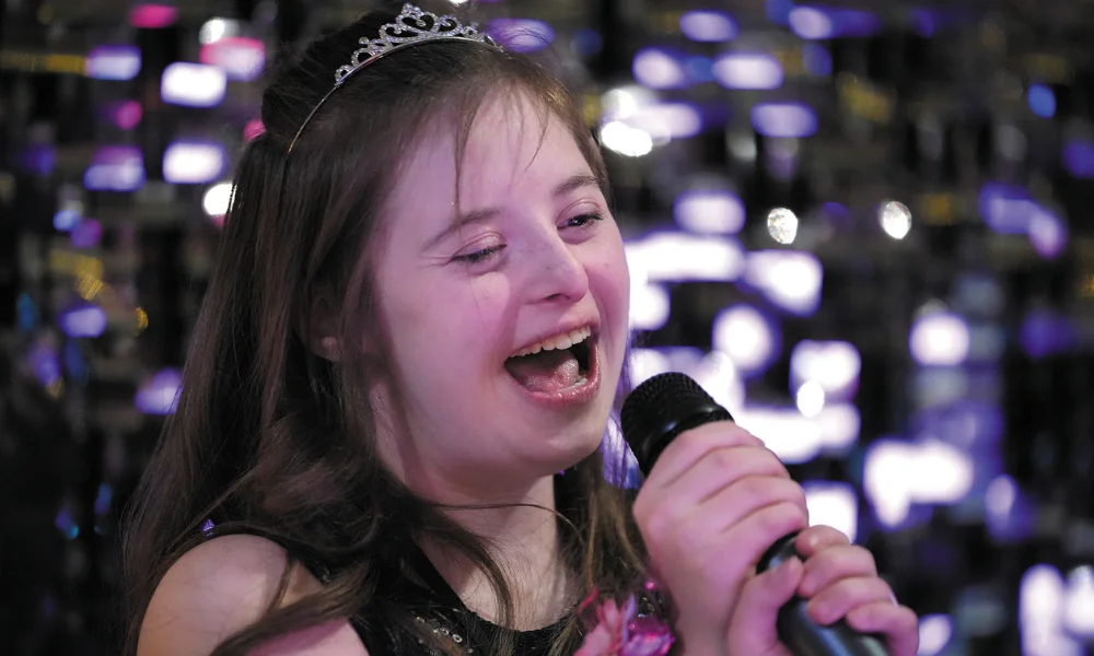 A young woman sings karoake at Night to Shine in Shenandoah A young woman sings karoake at Night to Shine in Shenandoah