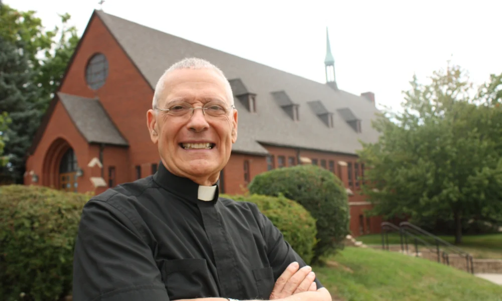 Monsignor Frank Bognanno stands outside Christ the King