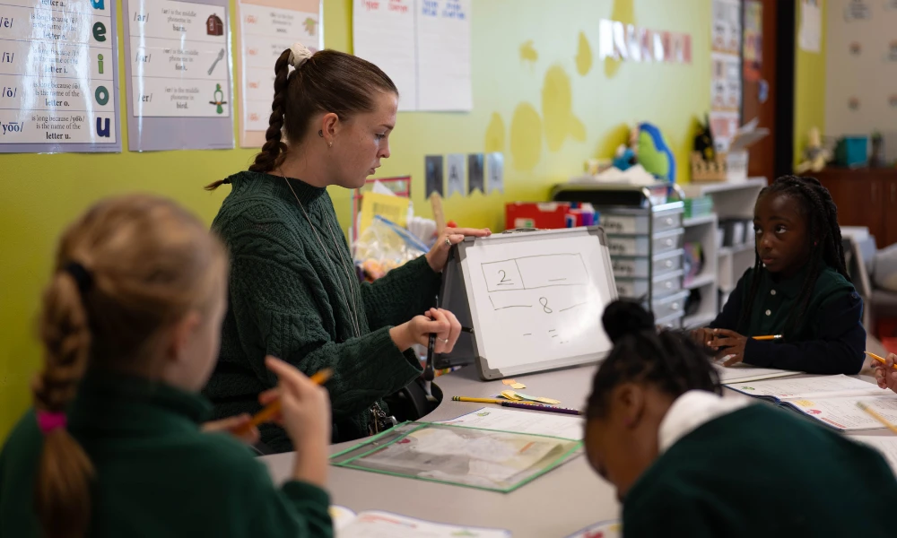 Catholic schools teacher helping students with math