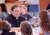 Father Ken Halbur with Catholic school students