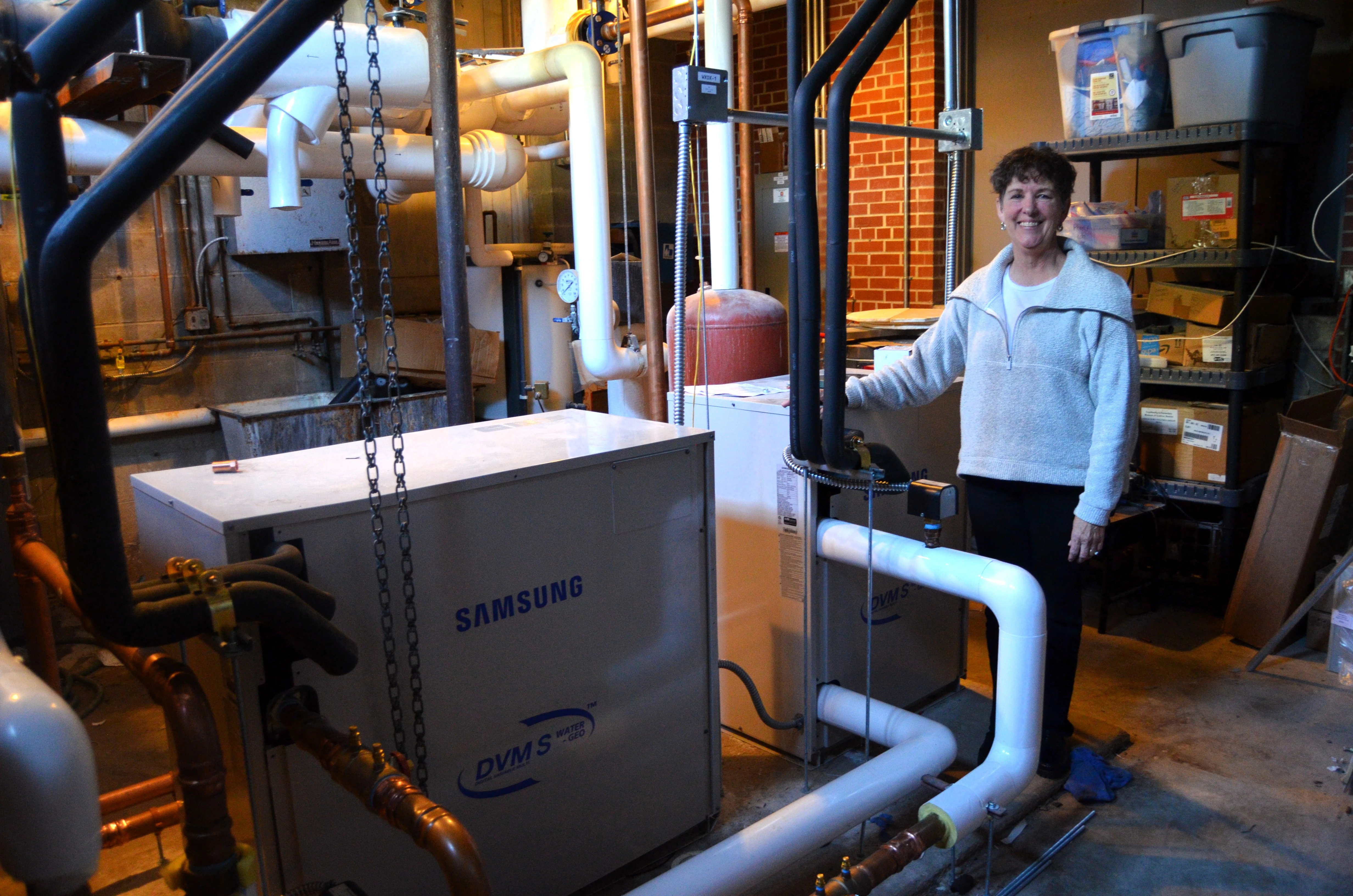 Mary Gisler stands next to the new geothermal technolog