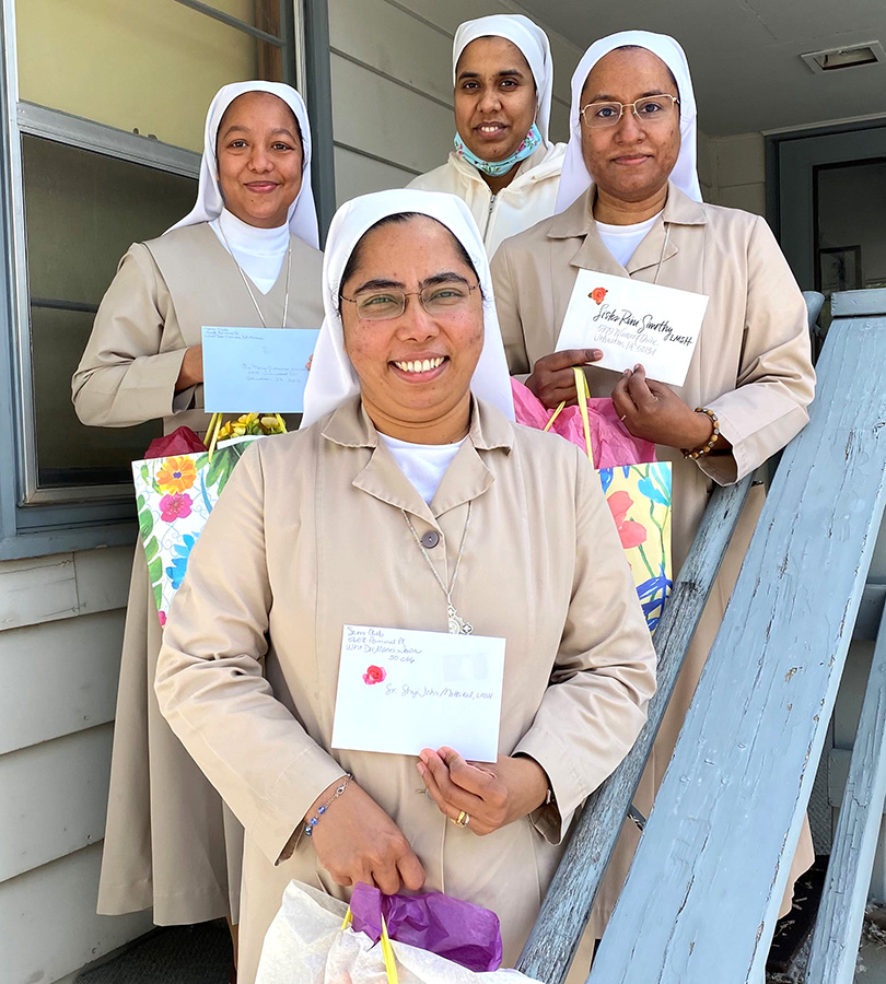 Religious women holding May Day gifts