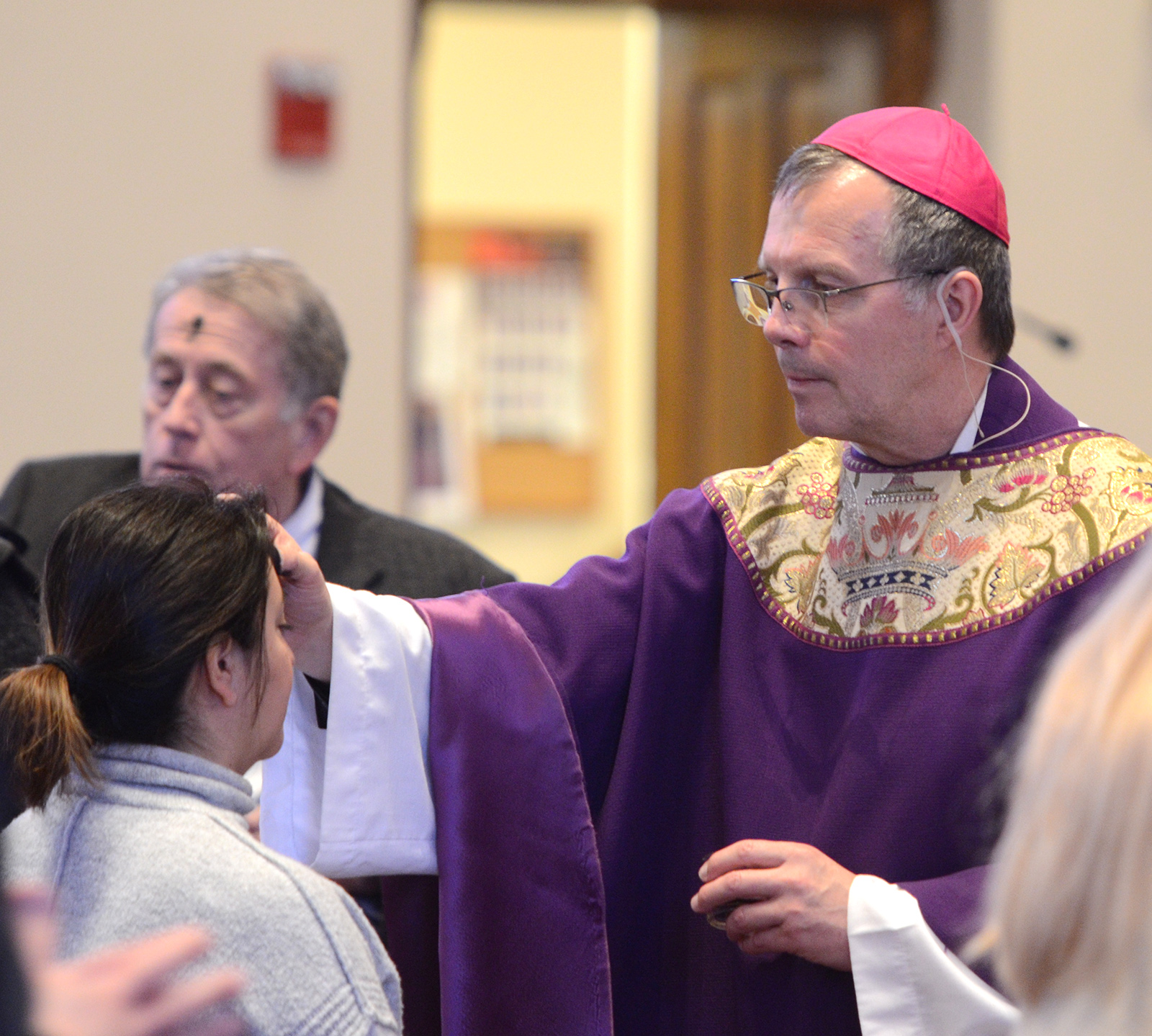 Bishop administers ashes on Ash Wednesday
